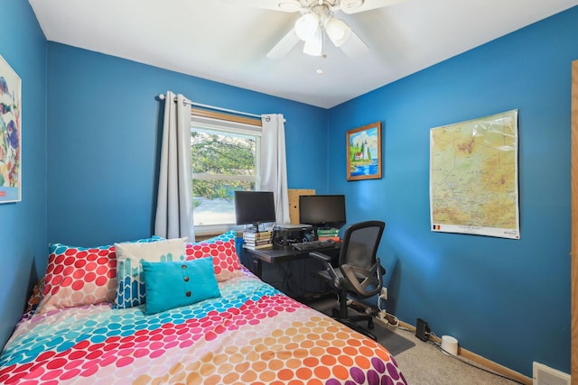 carpeted bedroom with a ceiling fan, visible vents, and baseboards