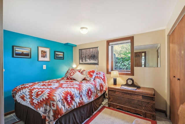 bedroom with a closet and baseboards