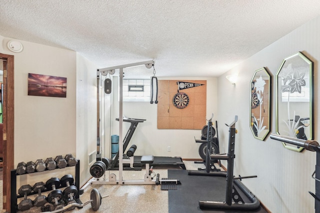 workout area featuring a textured ceiling