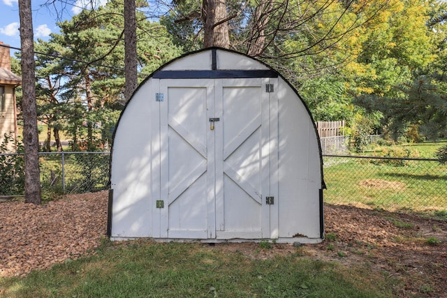 view of shed with fence