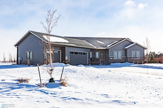 view of front of home featuring an attached garage and brick siding