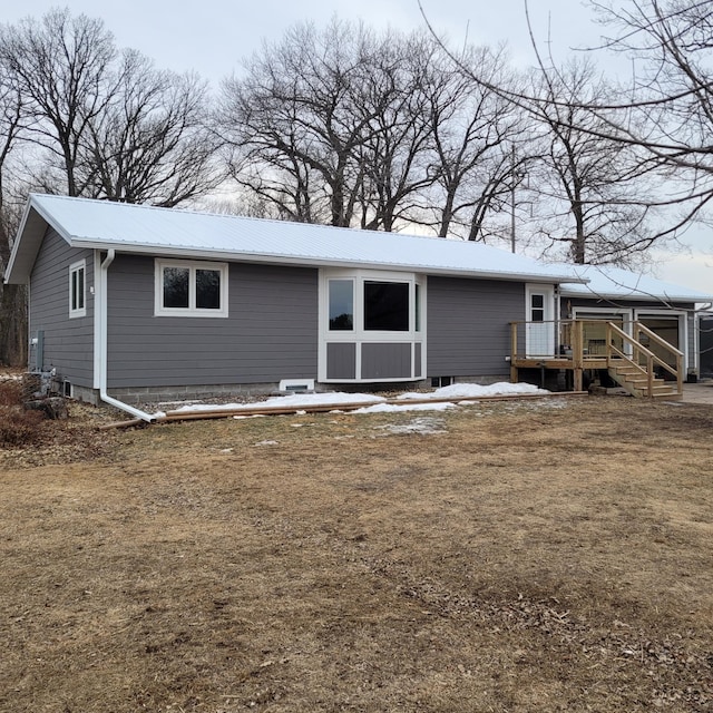 view of front of property featuring a deck and metal roof