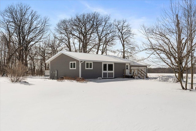 view of snow covered rear of property