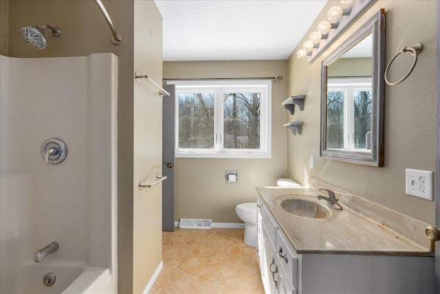 full bath featuring visible vents, toilet, a textured ceiling, vanity, and baseboards