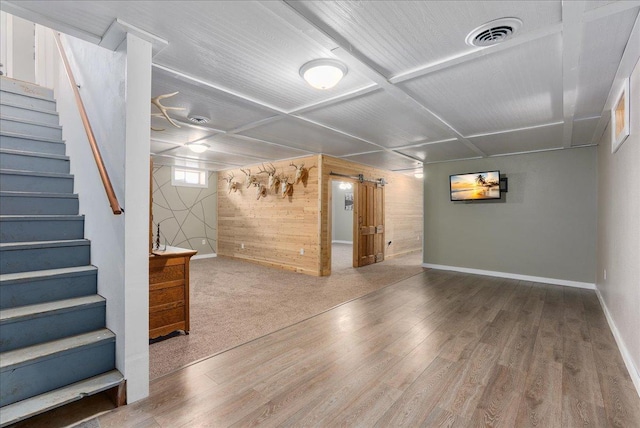 basement featuring stairway, wood finished floors, visible vents, and baseboards