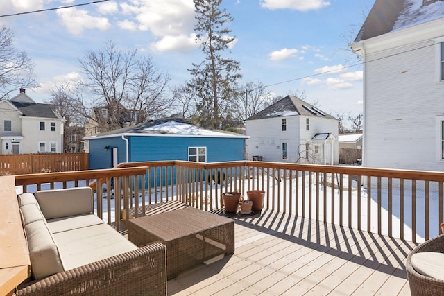 wooden deck with a residential view, outdoor lounge area, and an outdoor structure