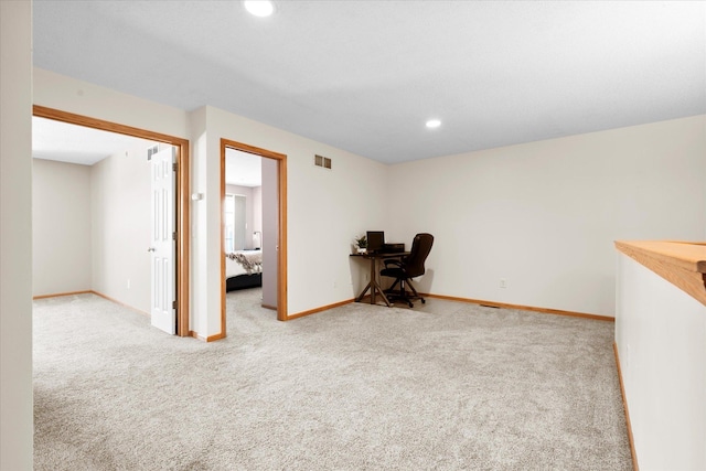 unfurnished office featuring carpet floors, visible vents, baseboards, and recessed lighting