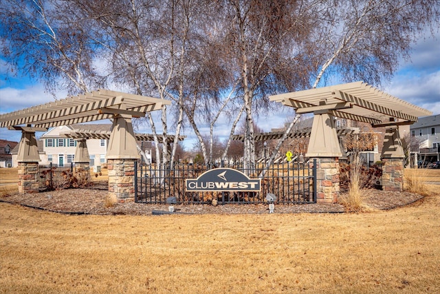 view of community featuring fence, a pergola, and a yard