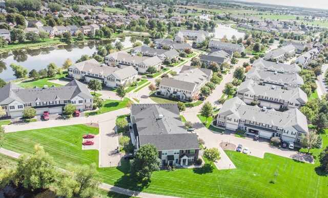 birds eye view of property featuring a water view and a residential view