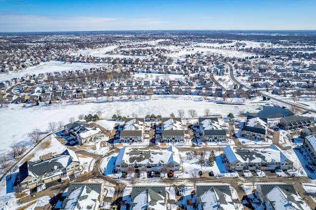 snowy aerial view with a residential view