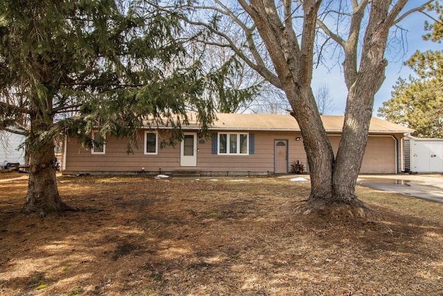 single story home with a garage and driveway