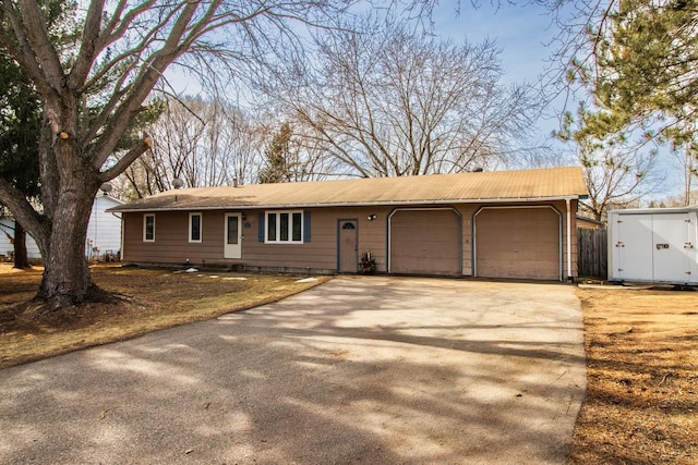 ranch-style home featuring driveway and an attached garage