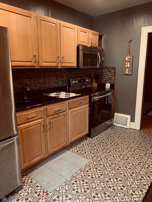 kitchen featuring dark countertops, tasteful backsplash, and stainless steel appliances