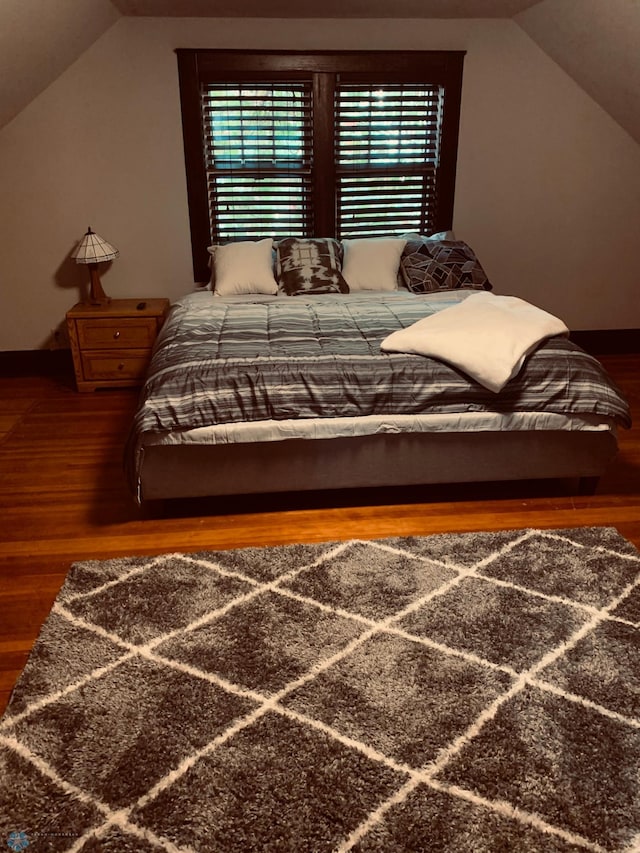 bedroom featuring vaulted ceiling and wood finished floors