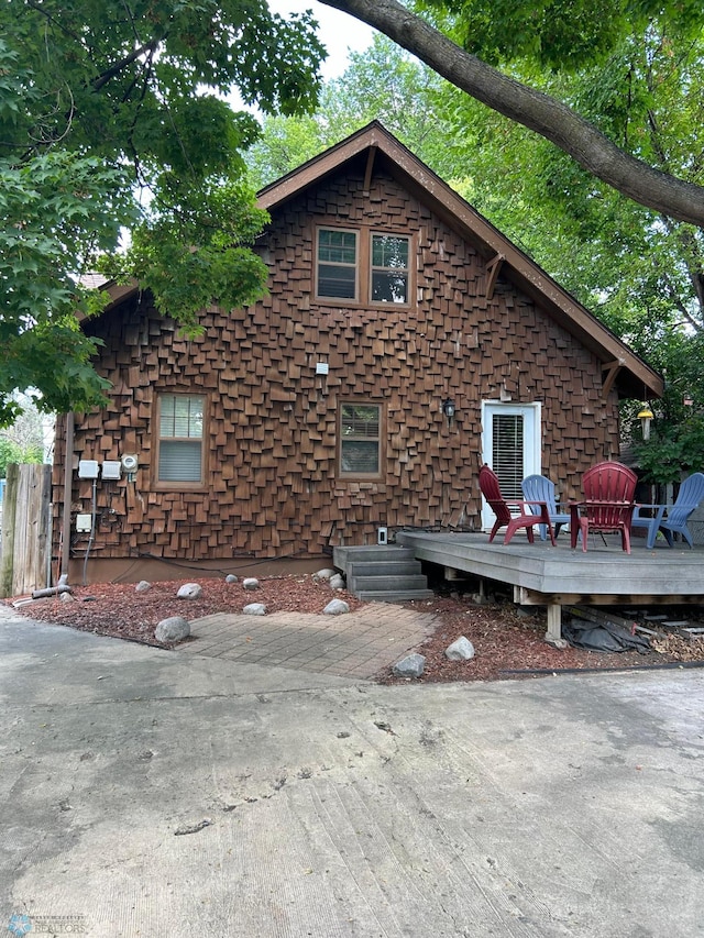 view of side of home with a deck