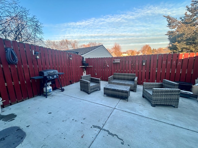 view of patio featuring a fenced backyard, a grill, and an outdoor hangout area