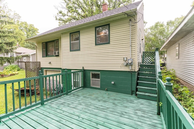 wooden terrace featuring stairs and a yard