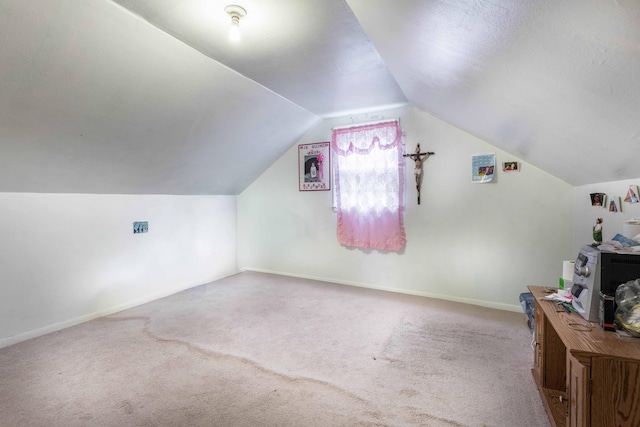 bonus room featuring carpet floors, vaulted ceiling, and baseboards