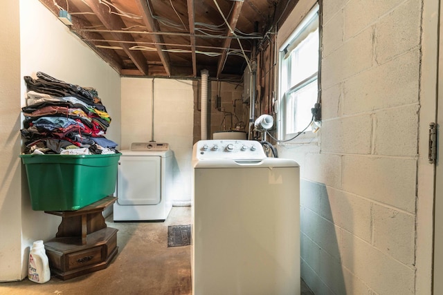 clothes washing area featuring laundry area and washing machine and clothes dryer