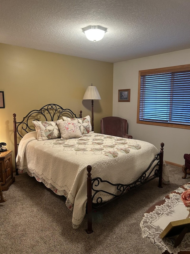 carpeted bedroom with a textured ceiling