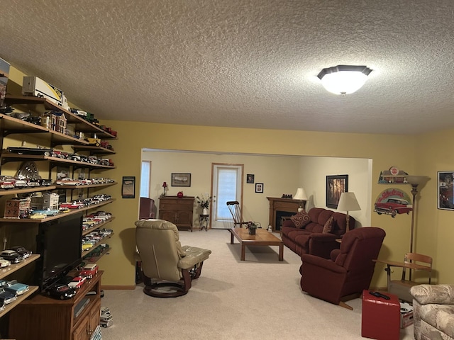 carpeted living area with a fireplace and a textured ceiling