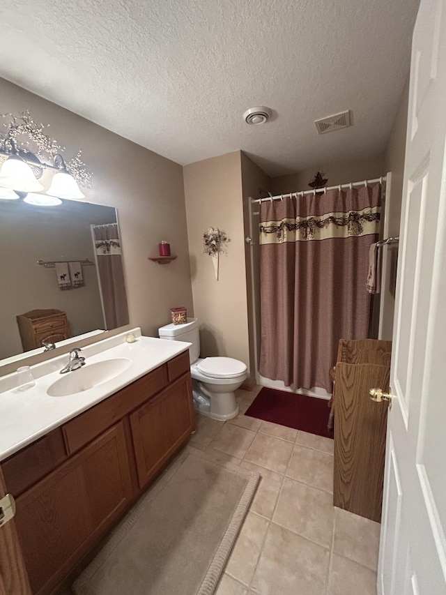 bathroom with toilet, tile patterned floors, vanity, visible vents, and a shower with curtain