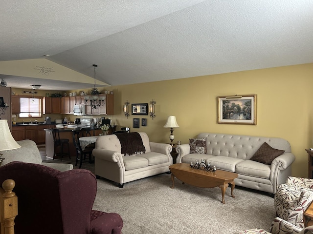 carpeted living room with lofted ceiling, an inviting chandelier, and a textured ceiling