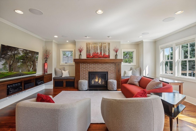 living area featuring recessed lighting, a brick fireplace, crown molding, baseboards, and wood finished floors