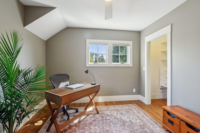 office space with lofted ceiling, ceiling fan, light wood-style flooring, and baseboards