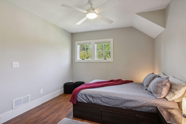 bedroom featuring baseboards, dark wood-style floors, visible vents, a ceiling fan, and lofted ceiling