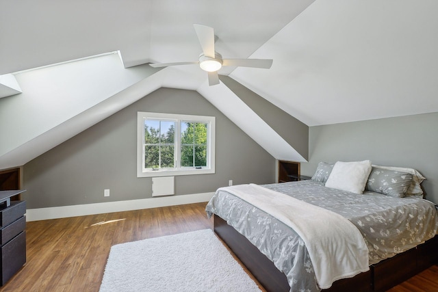 bedroom featuring lofted ceiling, a ceiling fan, wood finished floors, and baseboards