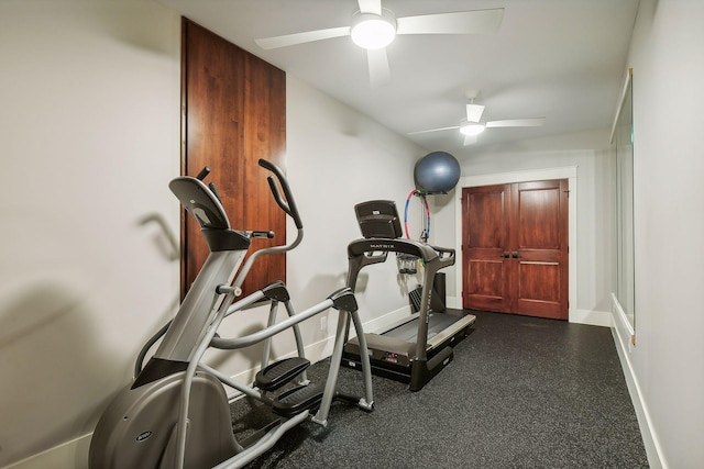 exercise room featuring a ceiling fan and baseboards