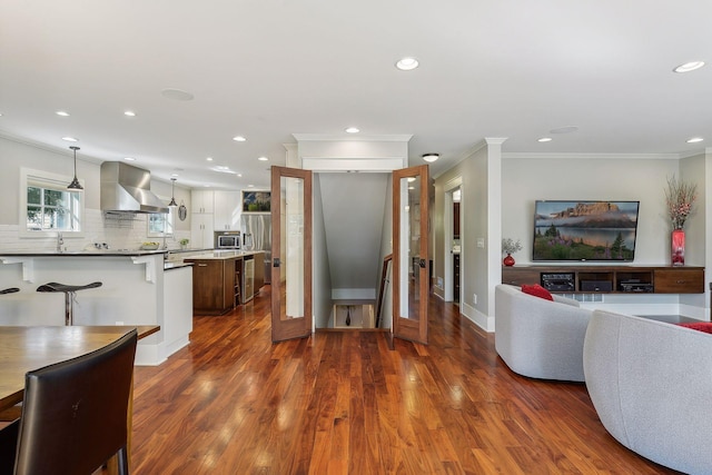 interior space featuring crown molding, beverage cooler, dark wood-style floors, baseboards, and recessed lighting