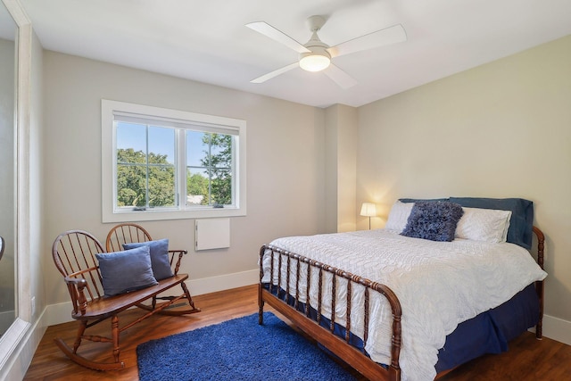 bedroom with baseboards, wood finished floors, and ceiling fan