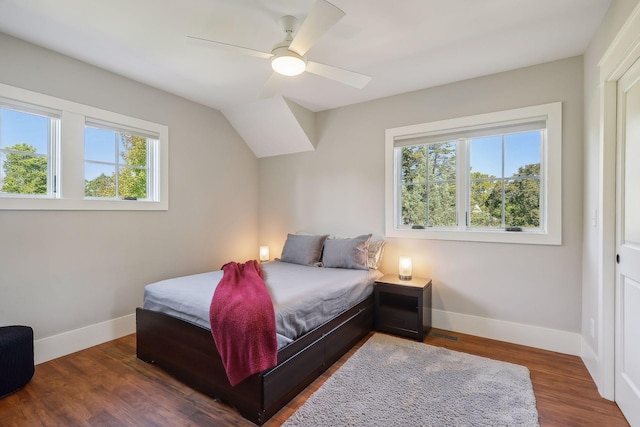 bedroom with a ceiling fan, visible vents, wood finished floors, and baseboards