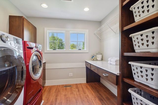 washroom featuring visible vents, washer and dryer, recessed lighting, wood finished floors, and laundry area