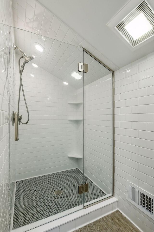 bathroom featuring visible vents and a shower stall
