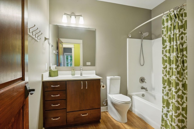 bathroom with shower / bath combo with shower curtain, wood finished floors, toilet, and vanity