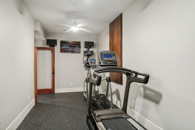 workout area featuring a ceiling fan and baseboards