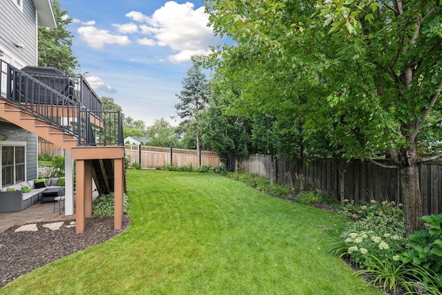 view of yard with stairway, an outdoor hangout area, a fenced backyard, and a patio area