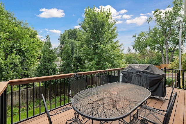 deck with grilling area and outdoor dining area