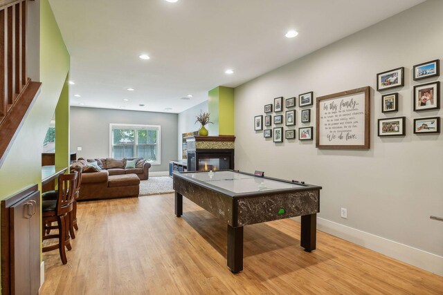 4015 Wood End Dr, Edina, MN 55424 - playroom with baseboards, light wood-style flooring, a multi sided fireplace, and recessed lighting