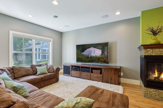4015 Wood End Dr, Edina, MN 55424 - living area featuring a glass covered fireplace, light wood finished floors, recessed lighting, and baseboards