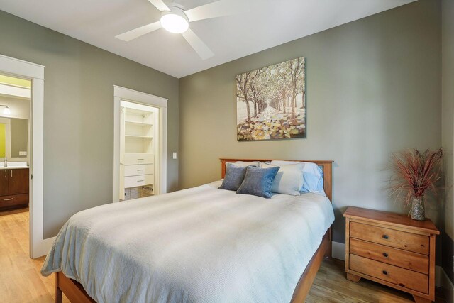 4015 Wood End Dr, Edina, MN 55424 - bedroom with light wood-style flooring, ensuite bathroom, and a ceiling fan