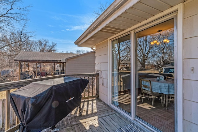 wooden terrace with a grill