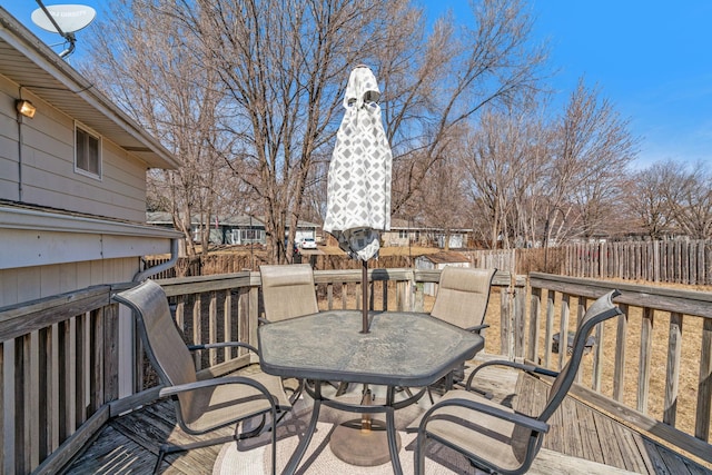 deck featuring outdoor dining space and fence