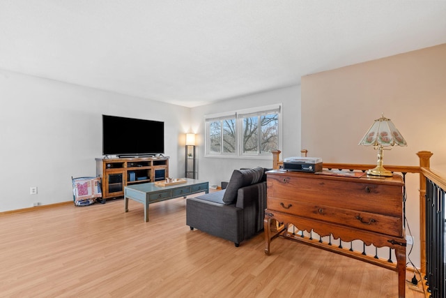 living room featuring baseboards and wood finished floors