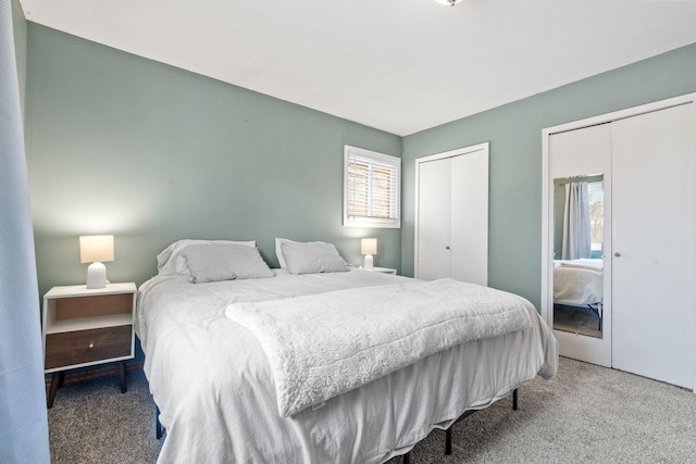 bedroom featuring multiple windows, two closets, and carpet