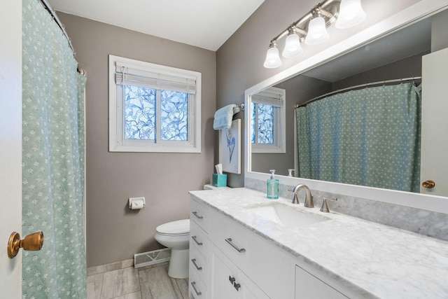 bathroom featuring visible vents, toilet, vanity, and baseboards