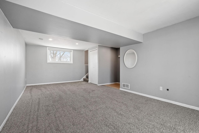 below grade area with stairway, baseboards, visible vents, recessed lighting, and carpet flooring